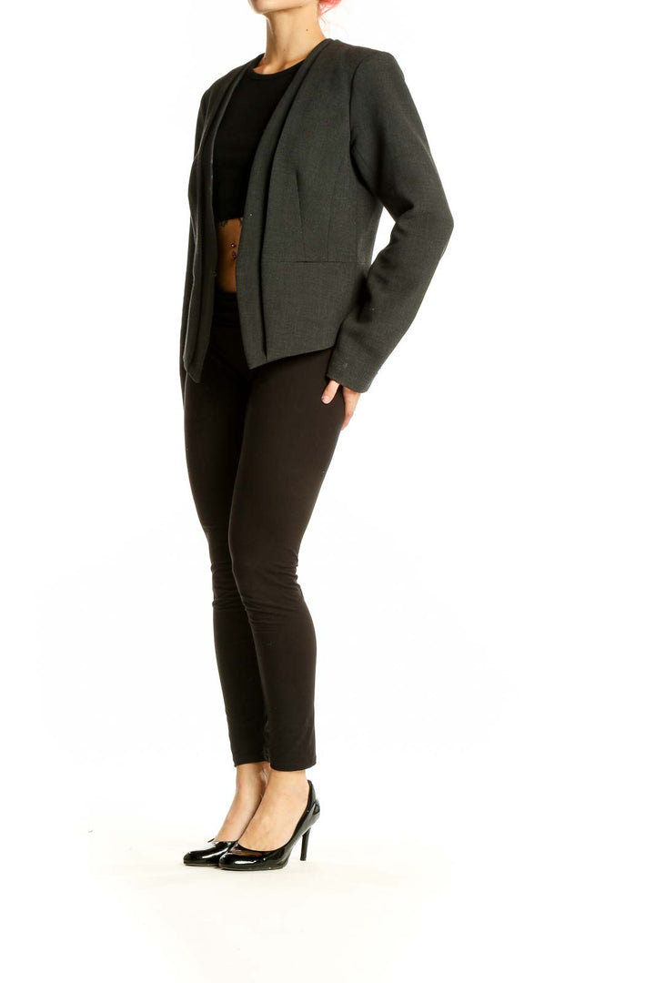 Front view of Trina Turk dark green open-front blazer on model