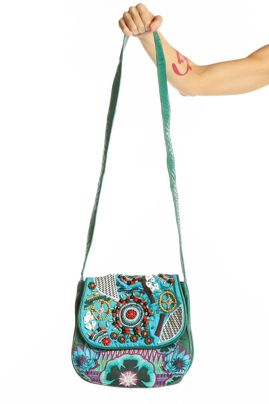 Front view of Desigual turquoise crossbody bag with colorful floral embroidery