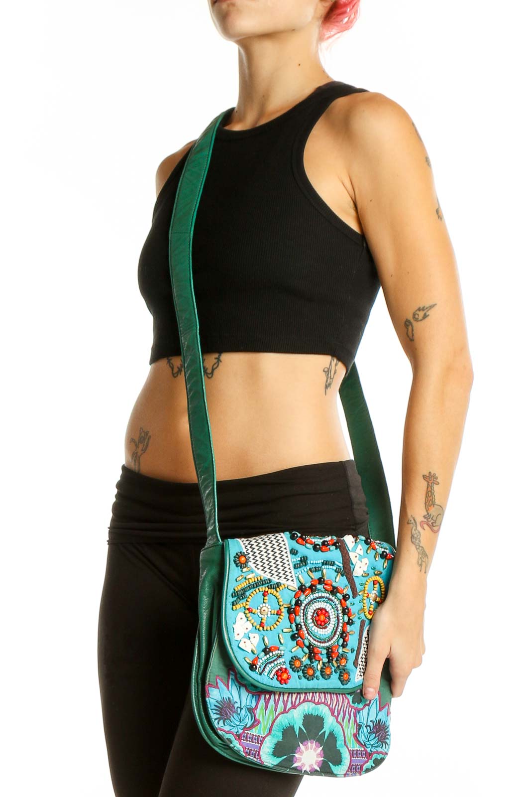 Front view of Desigual turquoise crossbody bag with colorful floral embroidery