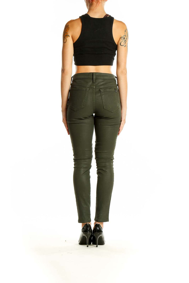 Side view of Joe's olive green skinny pants on model with black crop top