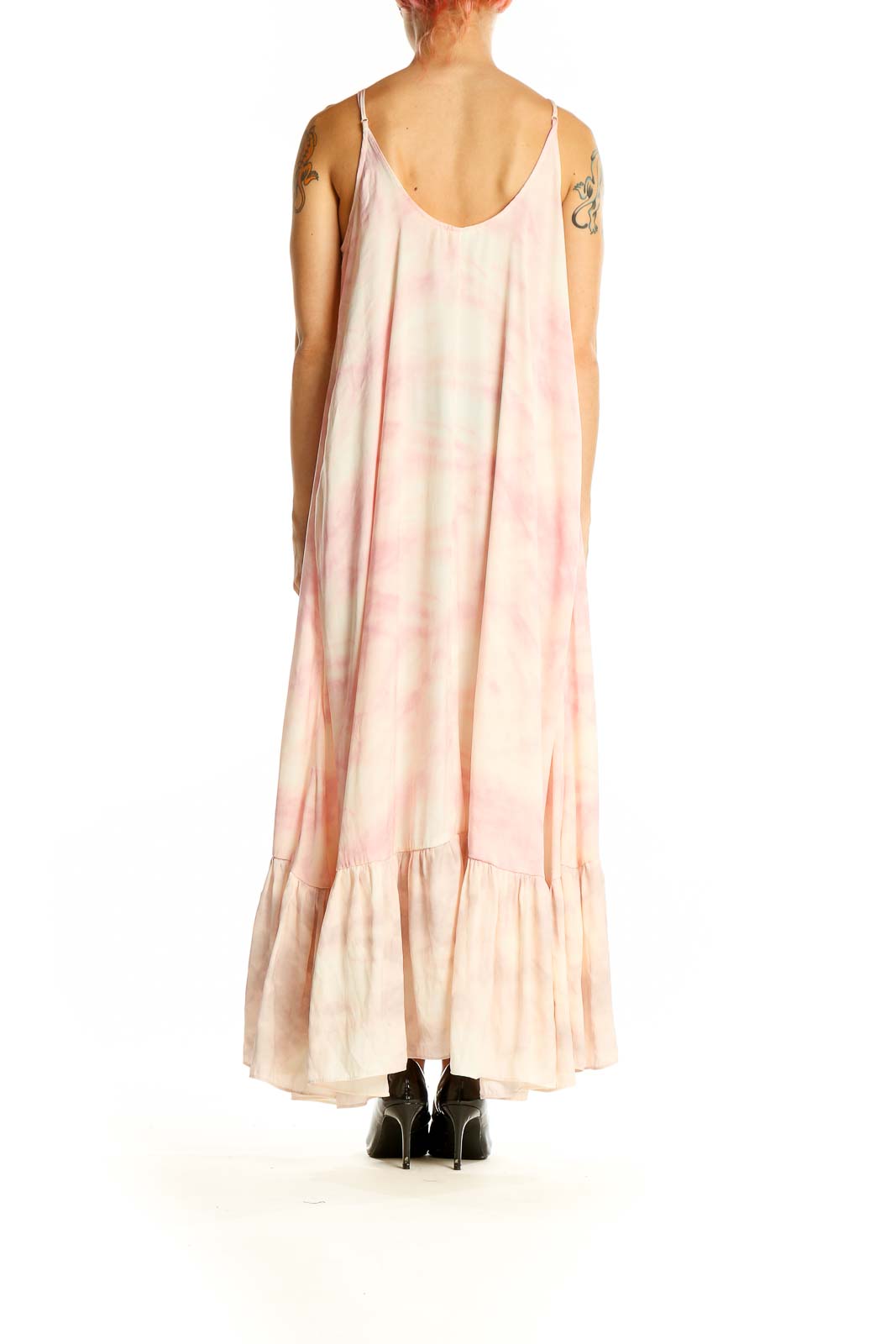 Side view of pink tie-dye maxi dress showing flowy silhouette and ruffle hem