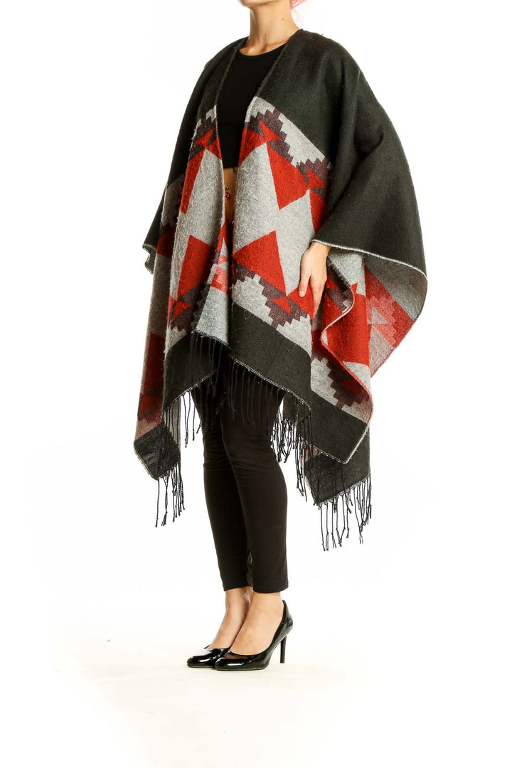 Front view of Oasis olive and red geometric knit poncho with fringed hem