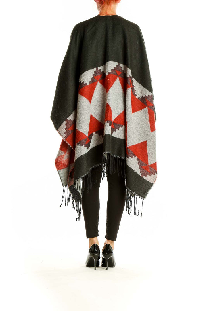 Back view of Oasis olive and red geometric knit poncho showing full pattern and drape