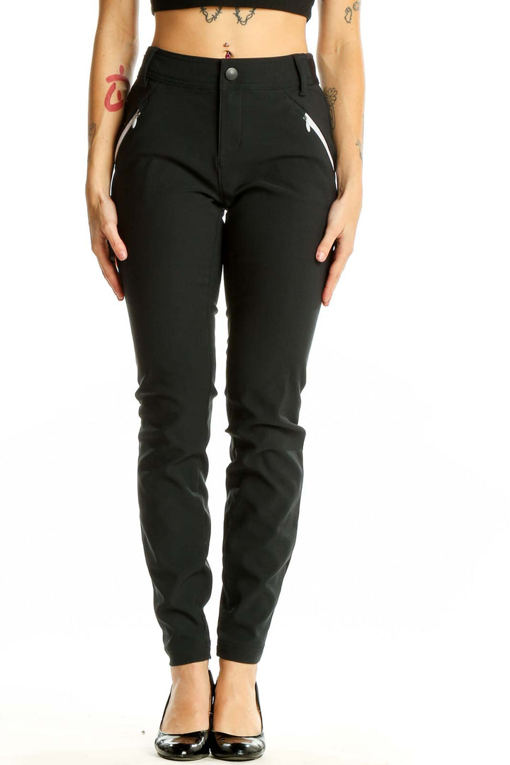 Front view of black Columbia slim-fit performance pants with zippered pockets