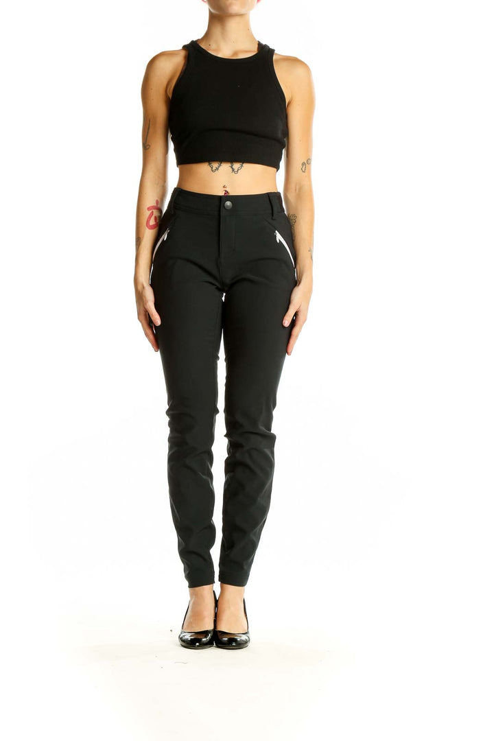 Front view of black Columbia slim-fit performance pants with zippered pockets