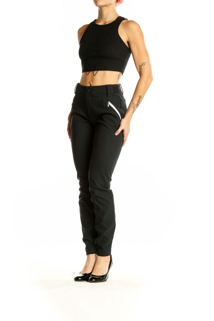 Front view of black Columbia slim-fit performance pants with zippered pockets