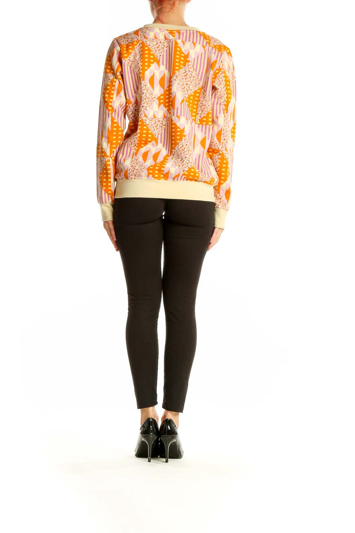 Back view of SagexClare orange geometric print cotton sweatshirt on model