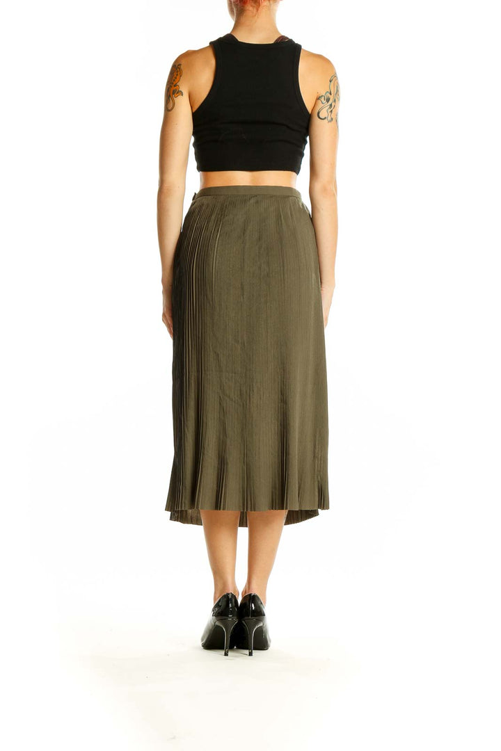 Side view of model wearing Noel Asmar olive pleated midi skirt with black top