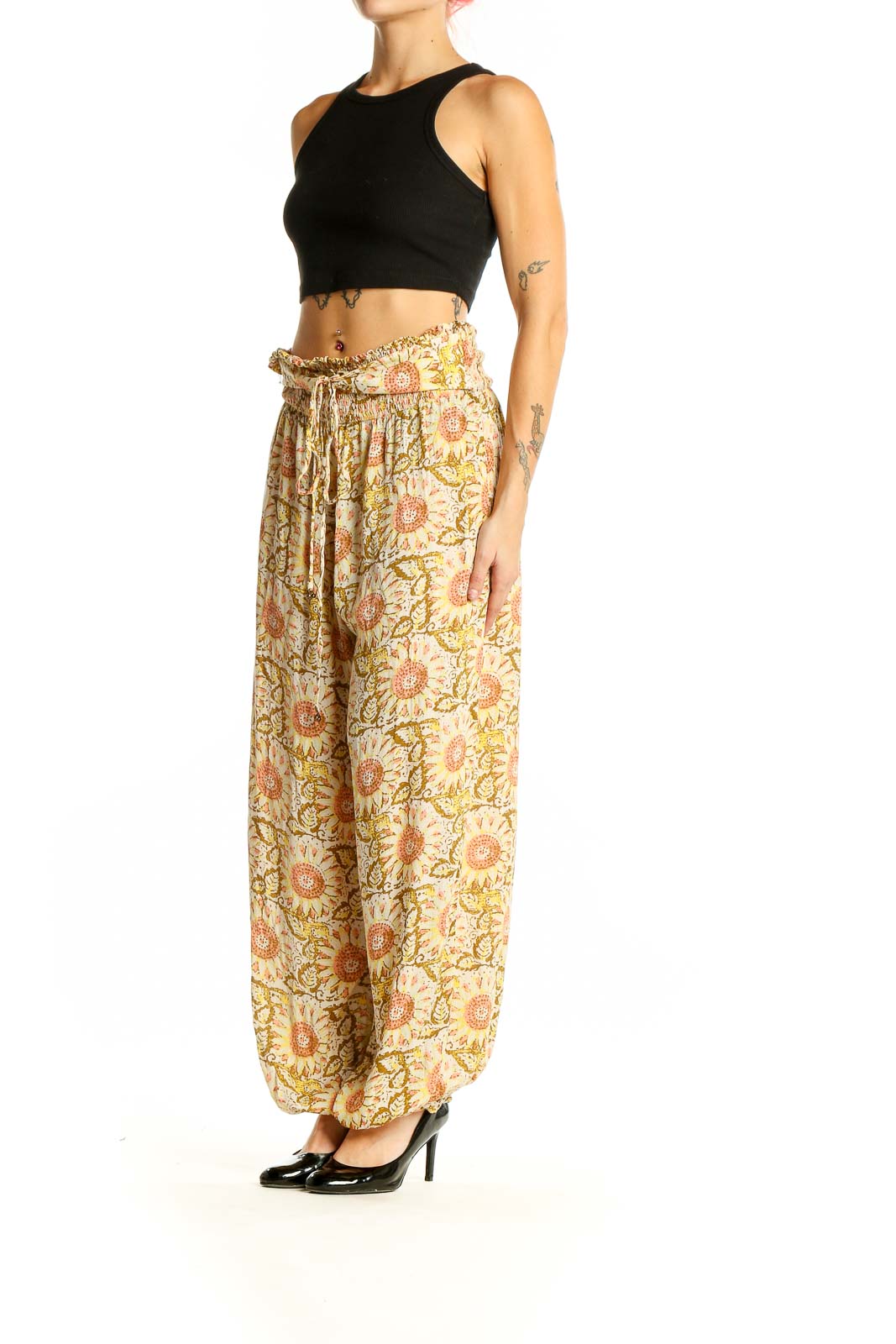 Front view of yellow floral harem pants by Intimately Free People