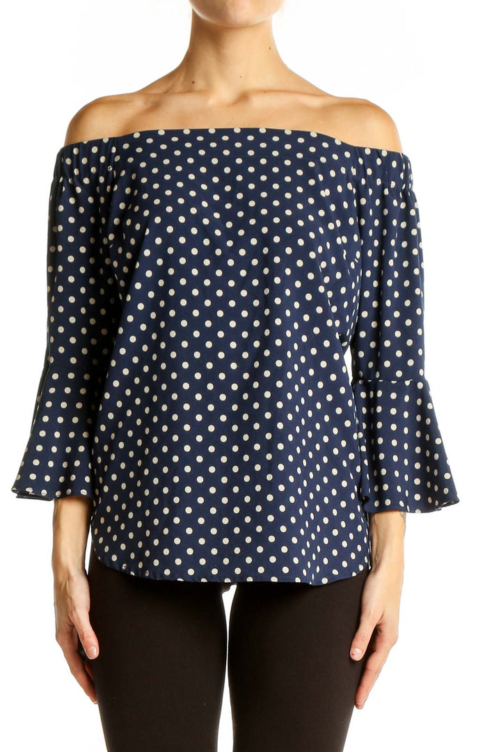 Front view of Camilla Tree navy polka dot off-shoulder top with bell sleeves