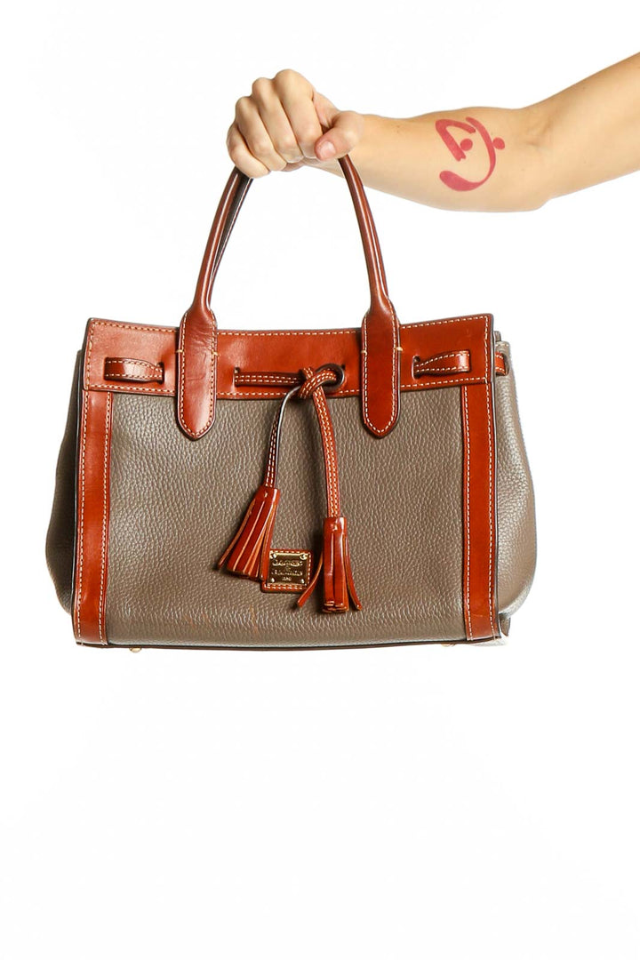 Front view of Dooney & Bourke taupe and orange leather satchel with tassels