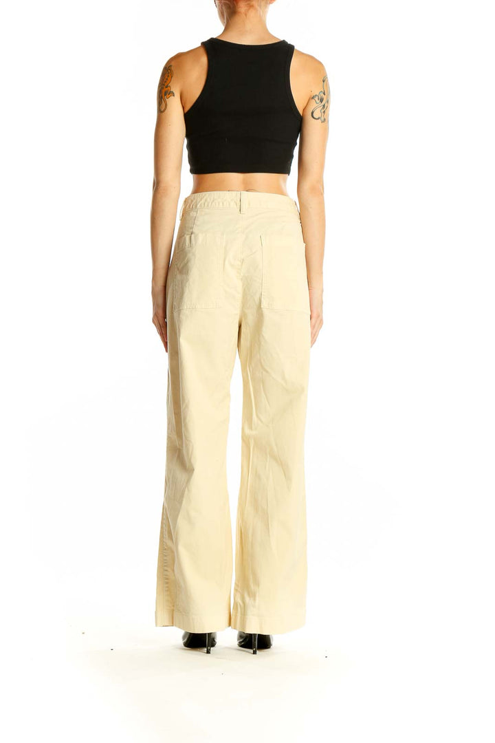 Side view of cream Gap wide-leg pants on model with black crop top