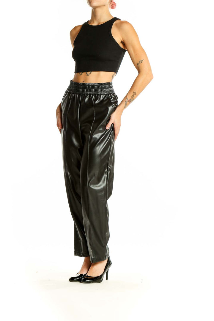 Front view of Maison D' Amelie Paris black faux leather wide-leg trousers