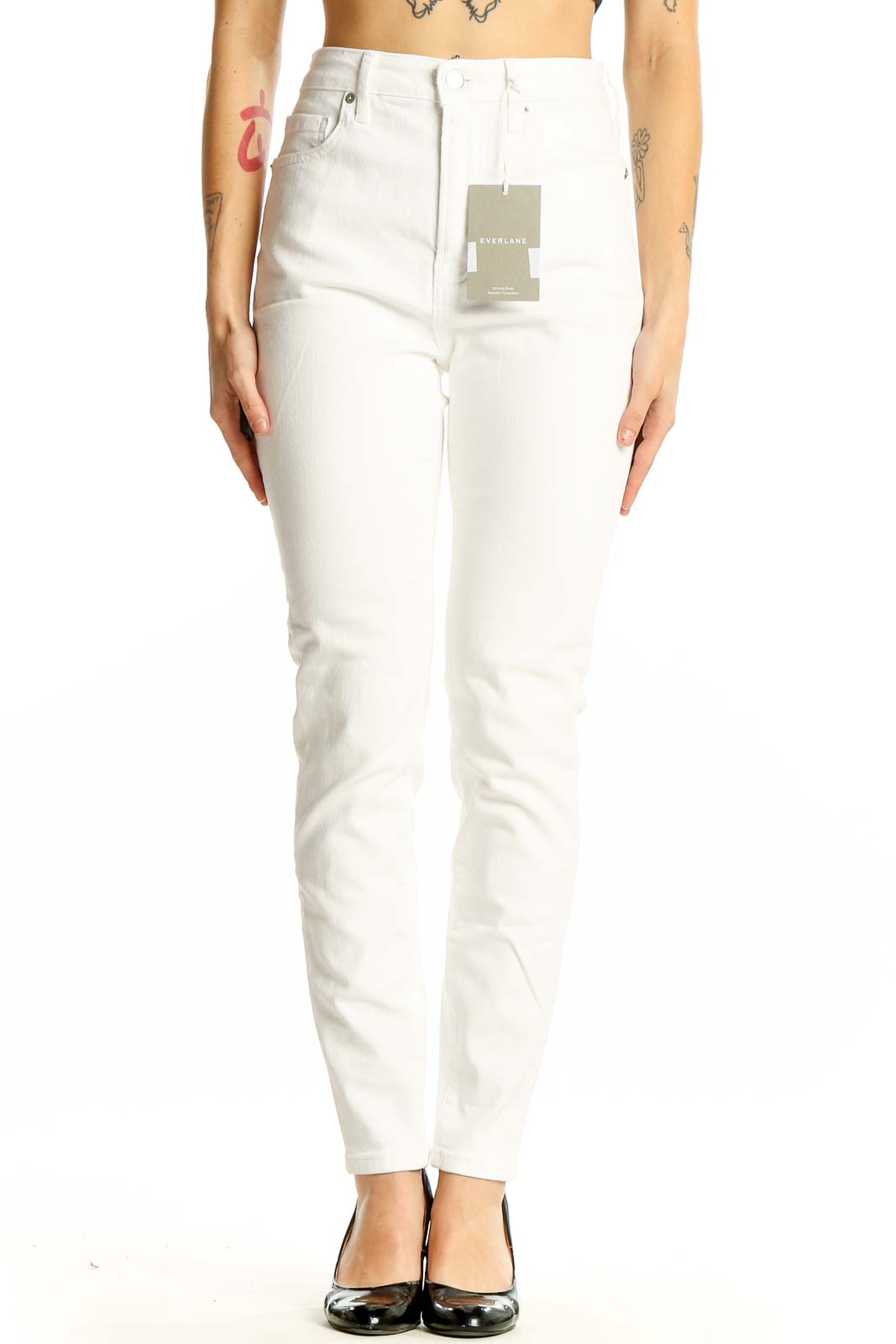 Front view of Everlane white high-waisted slim fit jeans on model