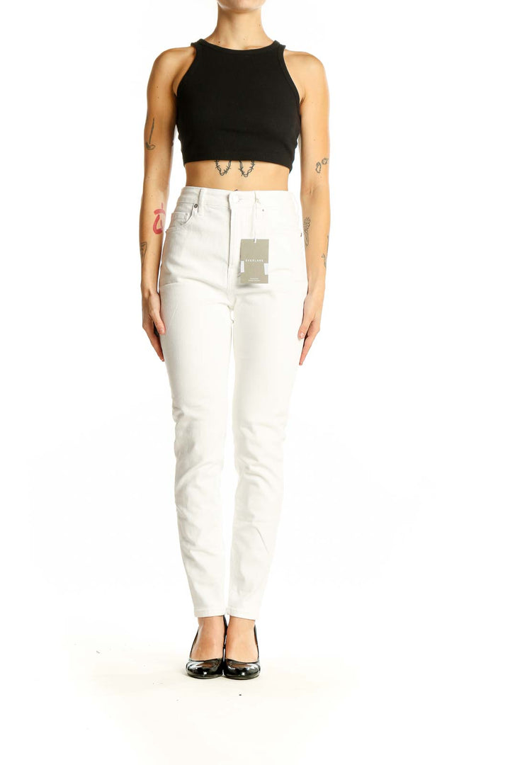 Front view of Everlane white high-waisted slim fit jeans on model