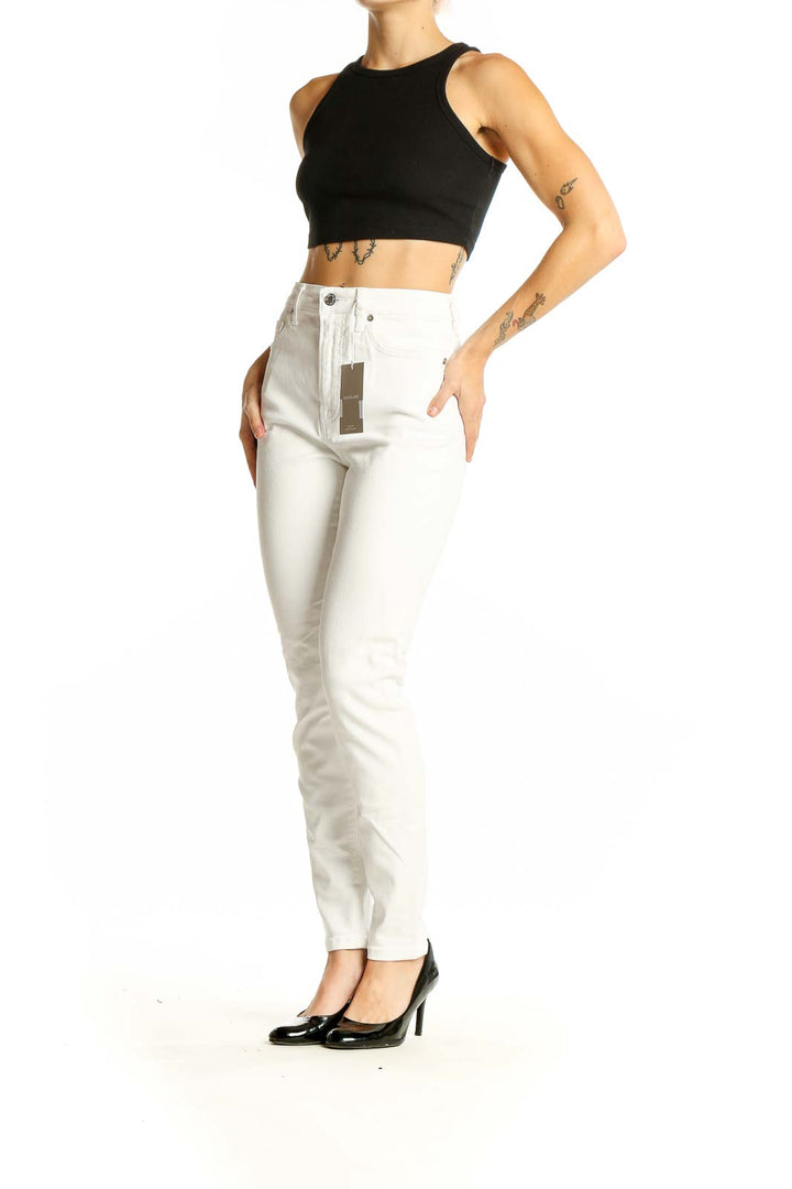 Front view of Everlane white high-waisted slim fit jeans on model