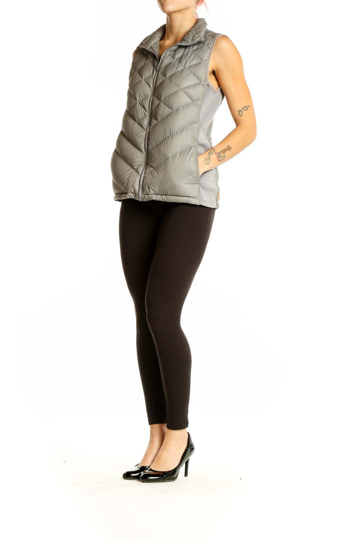 Front view of gray quilted puffer vest by Lucy with chevron pattern