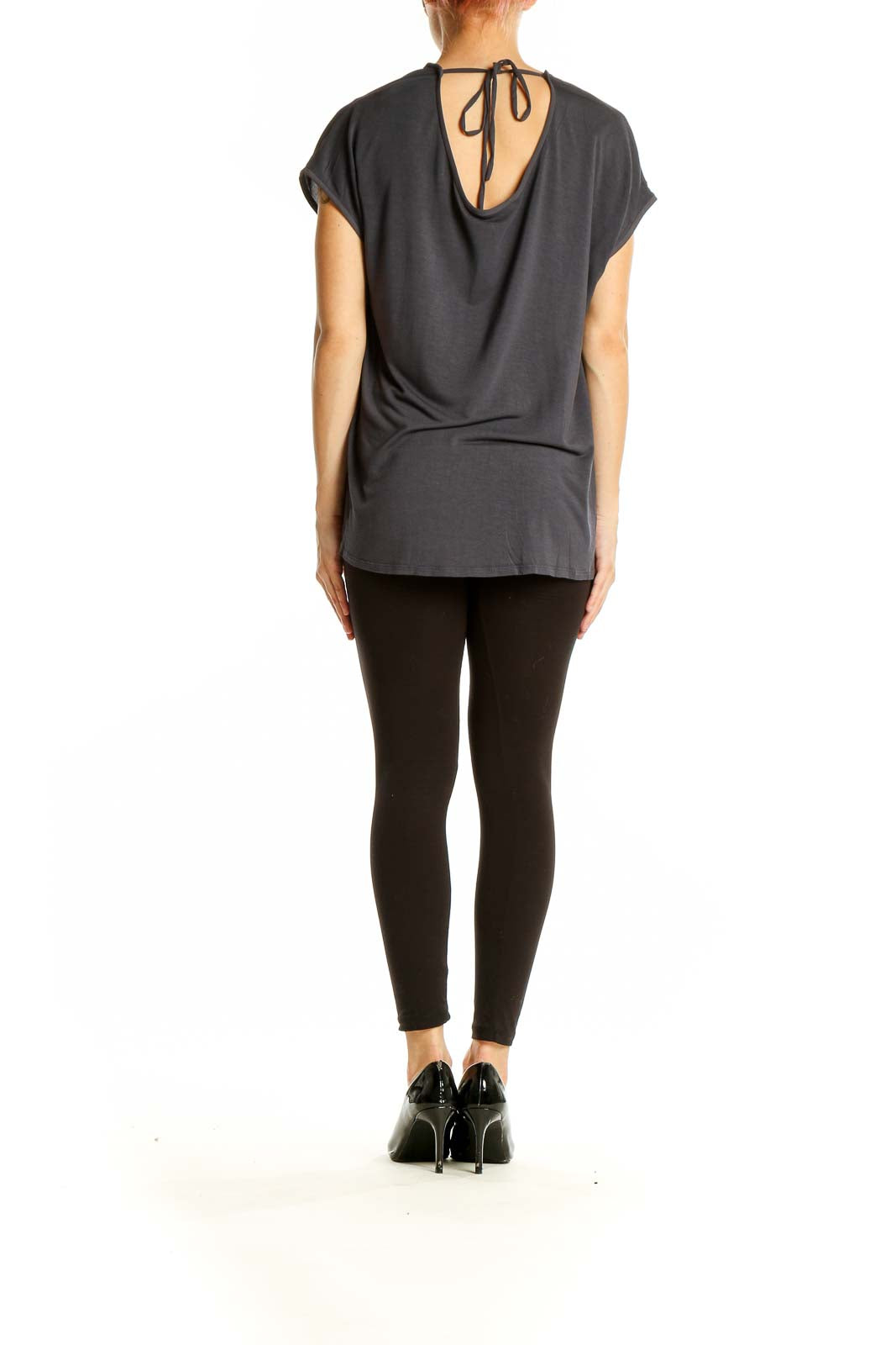 Side view of gray LOFT flowy short-sleeve blouse on model with black pants