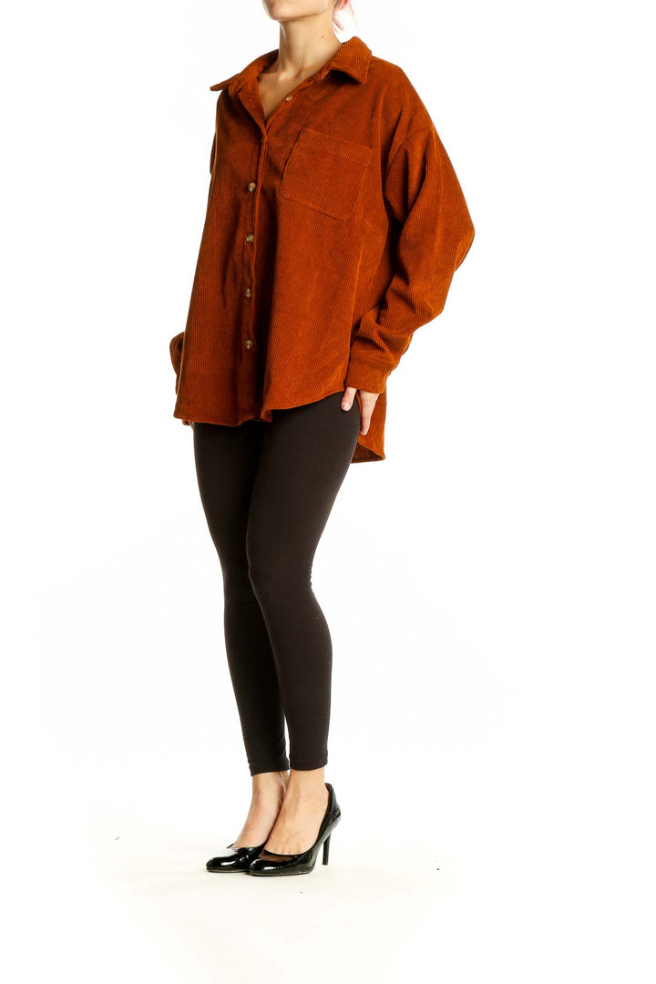 Front view of rust-colored corduroy oversized button-down shirt by SilkRoll