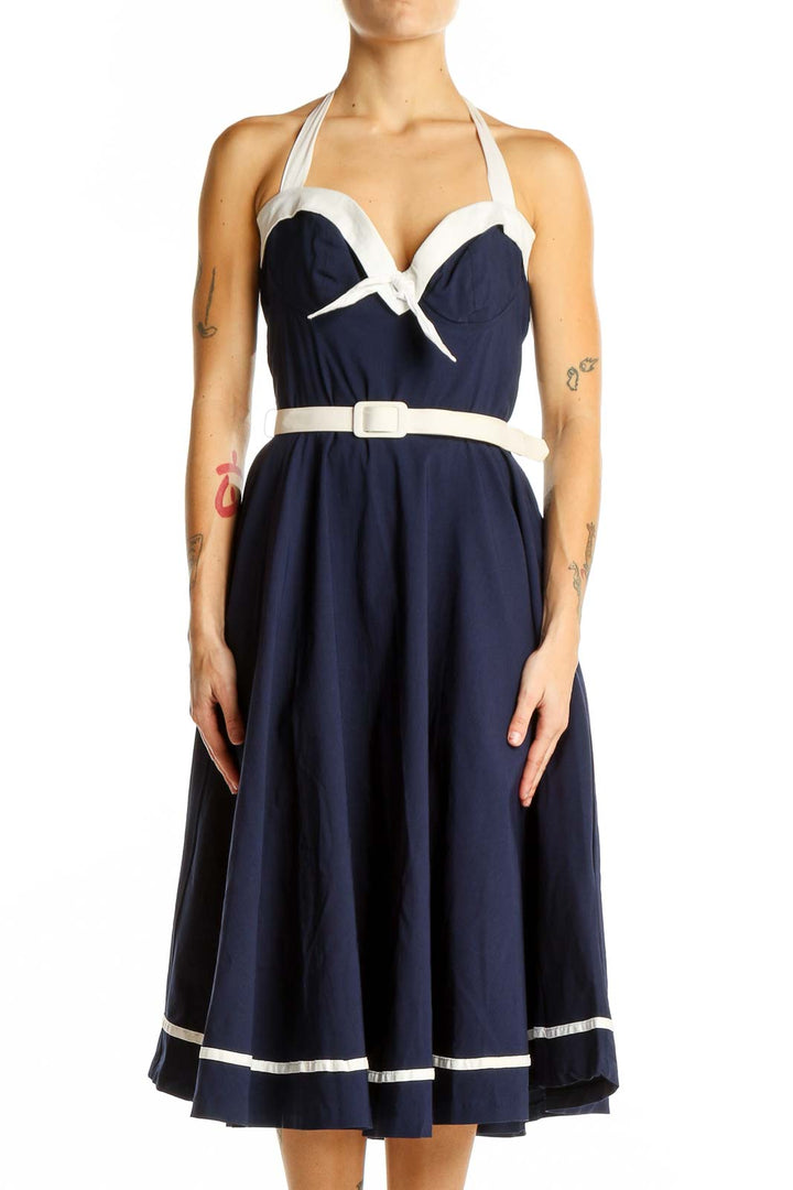 Front view of navy Pinup Couture halter swing dress with white trim and belt