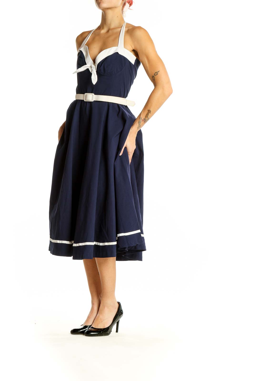 Front view of navy Pinup Couture halter swing dress with white trim and belt