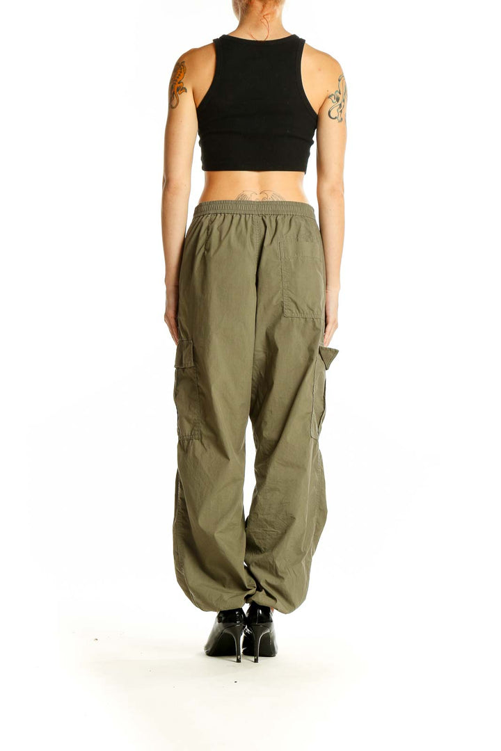 Side view of Uniqlo olive green cargo pants on model with black crop top