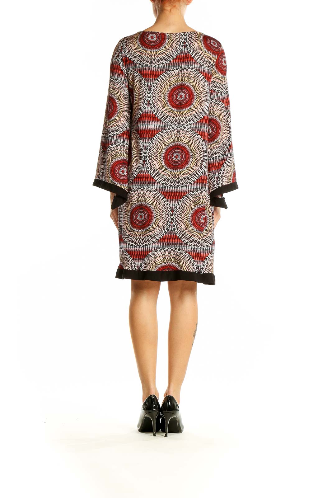 Back view of Emma & Michele red circular pattern shift dress with long sleeves