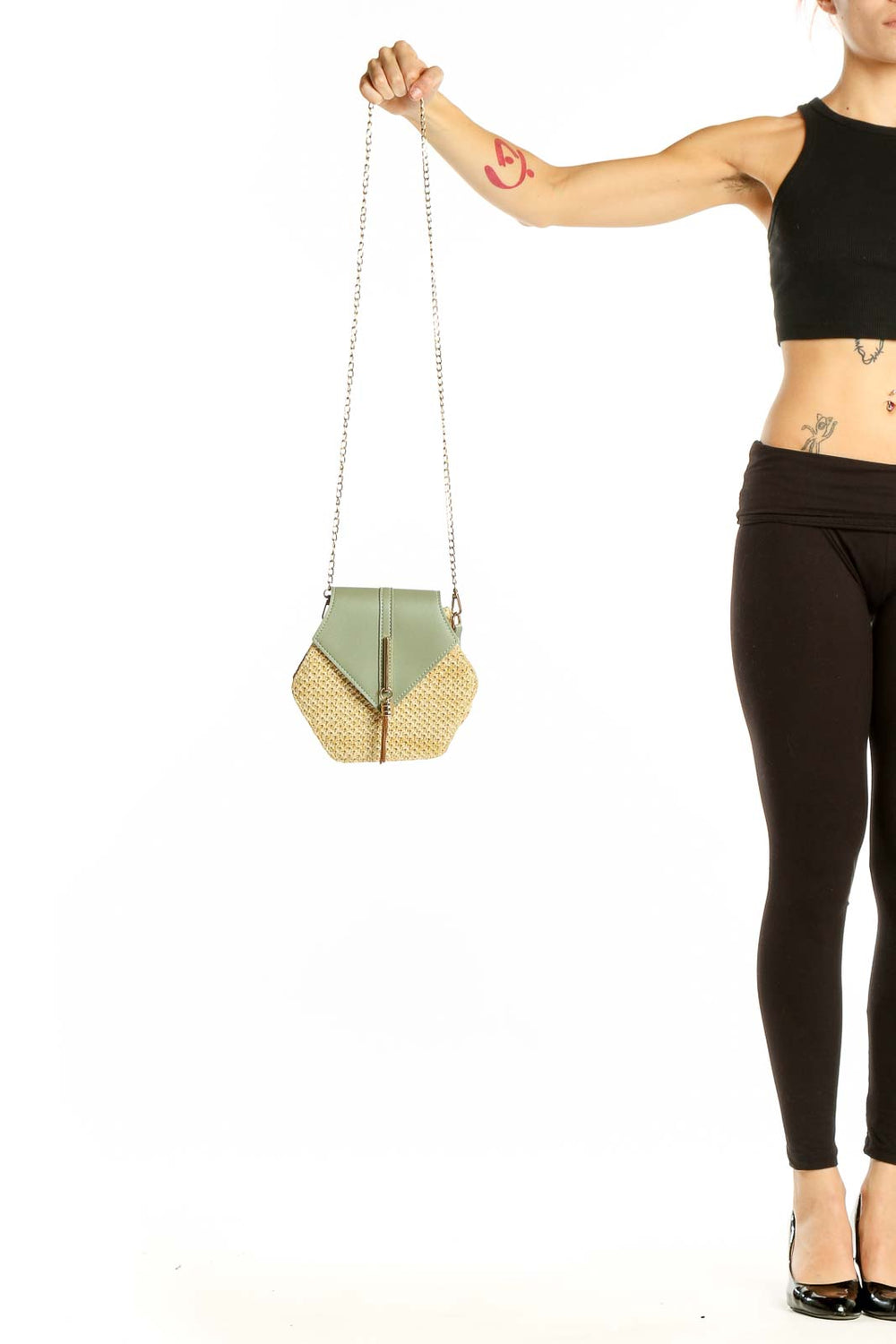 Front view of SilkRoll sage green and straw hexagonal clutch with chain strap