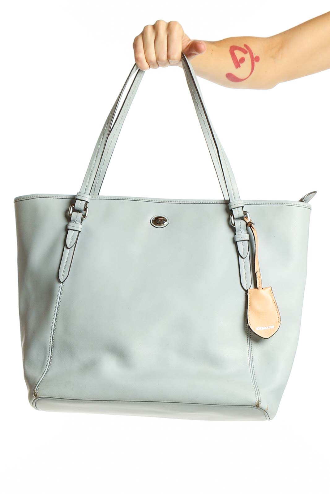 Front view of light blue leather Coach tote bag with adjustable straps