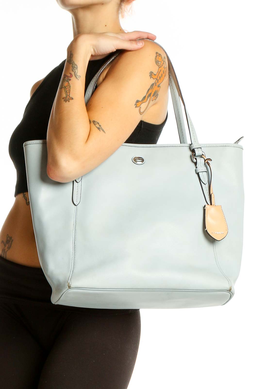 Front view of light blue leather Coach tote bag with adjustable straps