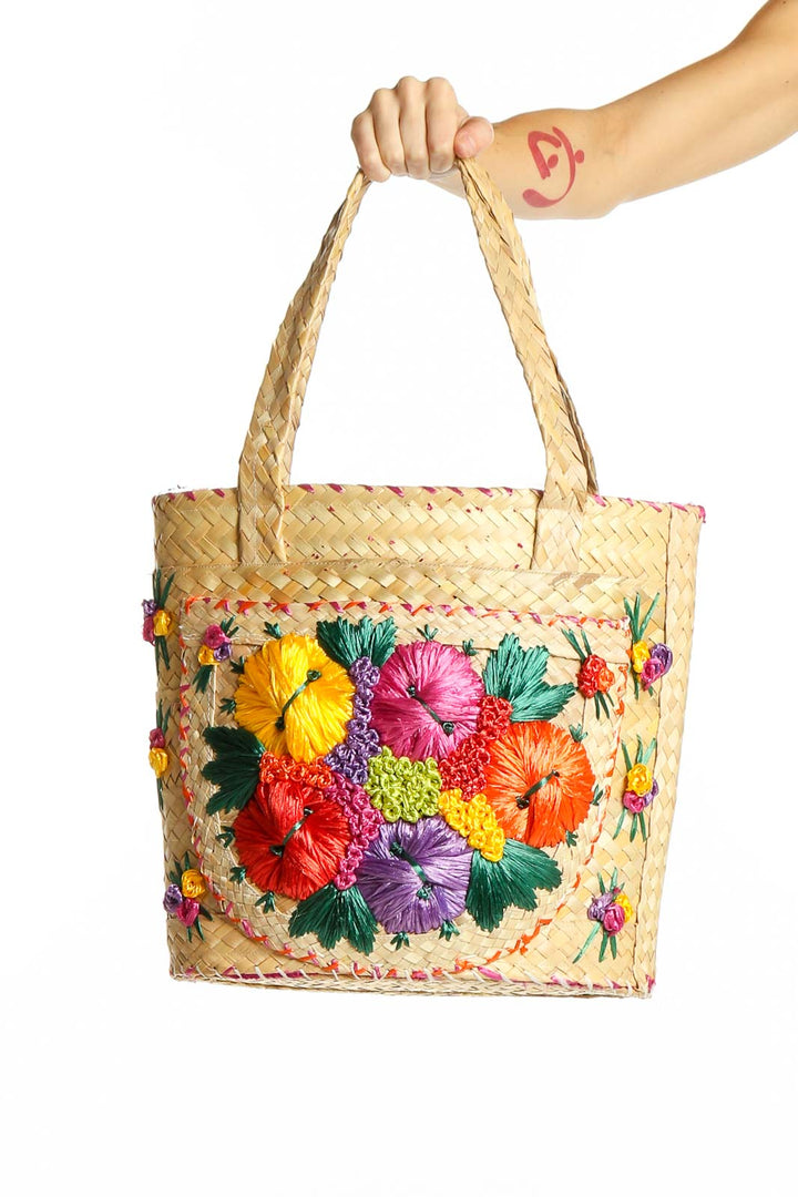 Front view of SilkRoll natural woven tote bag with colorful floral embroidery