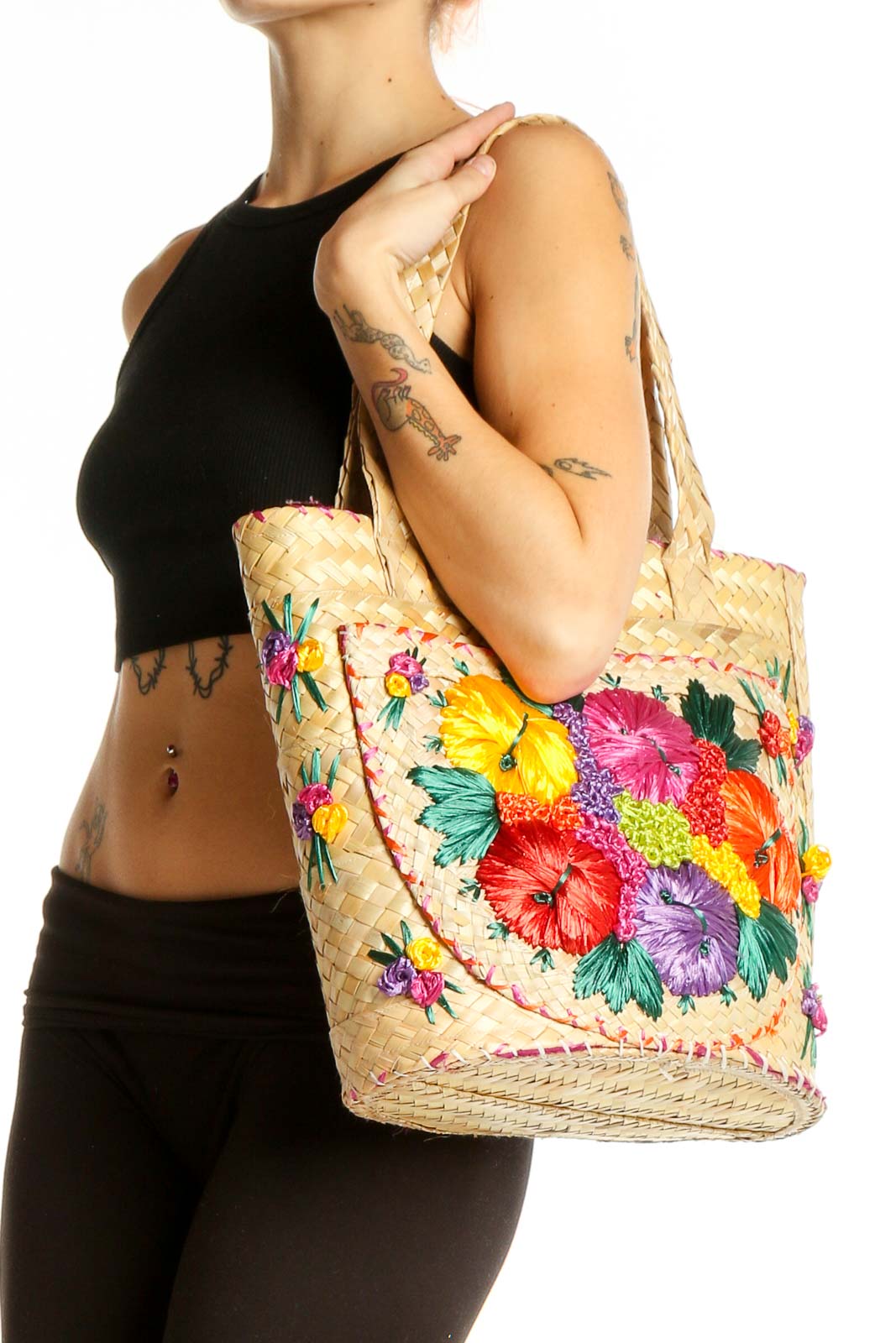 Front view of SilkRoll natural woven tote bag with colorful floral embroidery