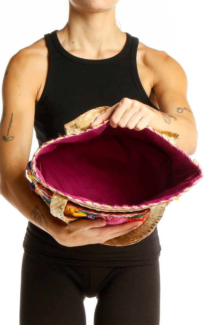 Side view of model carrying SilkRoll natural woven tote bag with floral embroidery