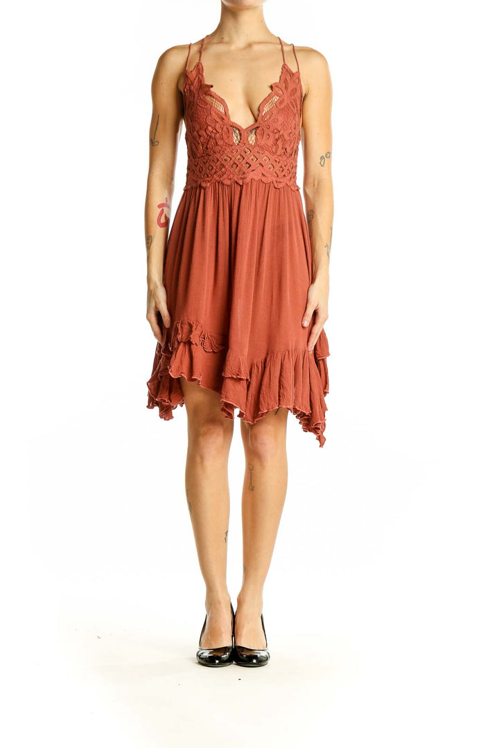 Front view of Free People terracotta mini dress with lace bodice and flowy skirt