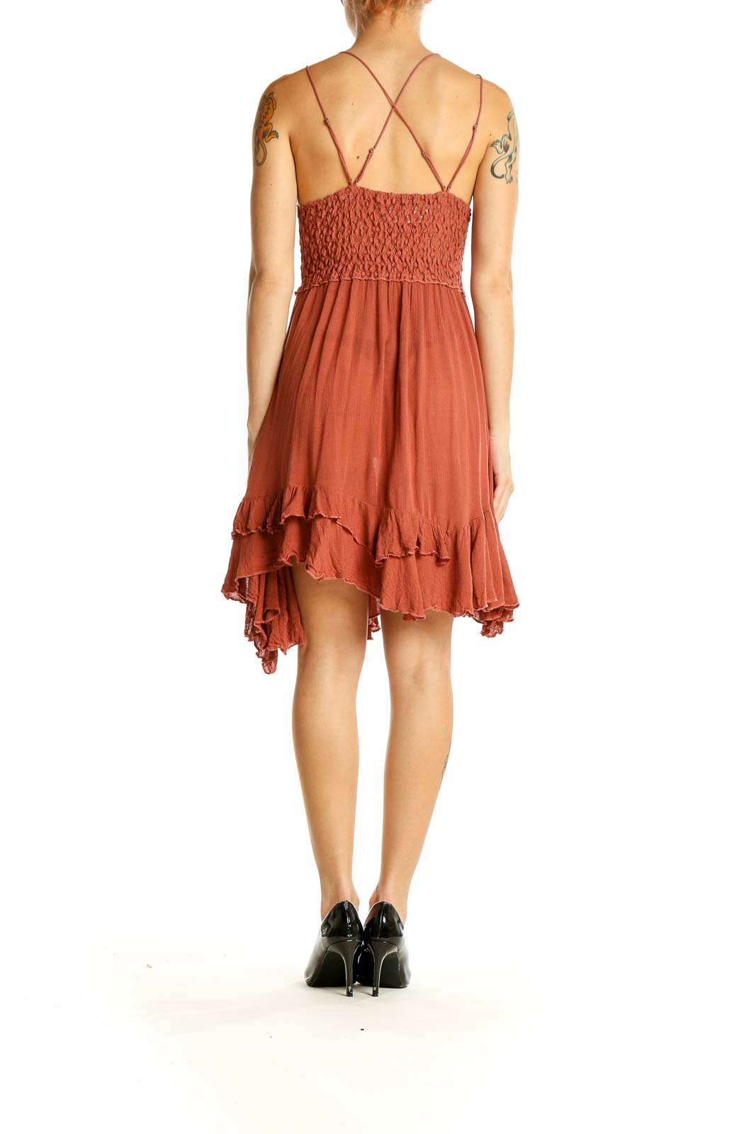 Side view of Free People terracotta mini dress showing asymmetrical ruffled hem