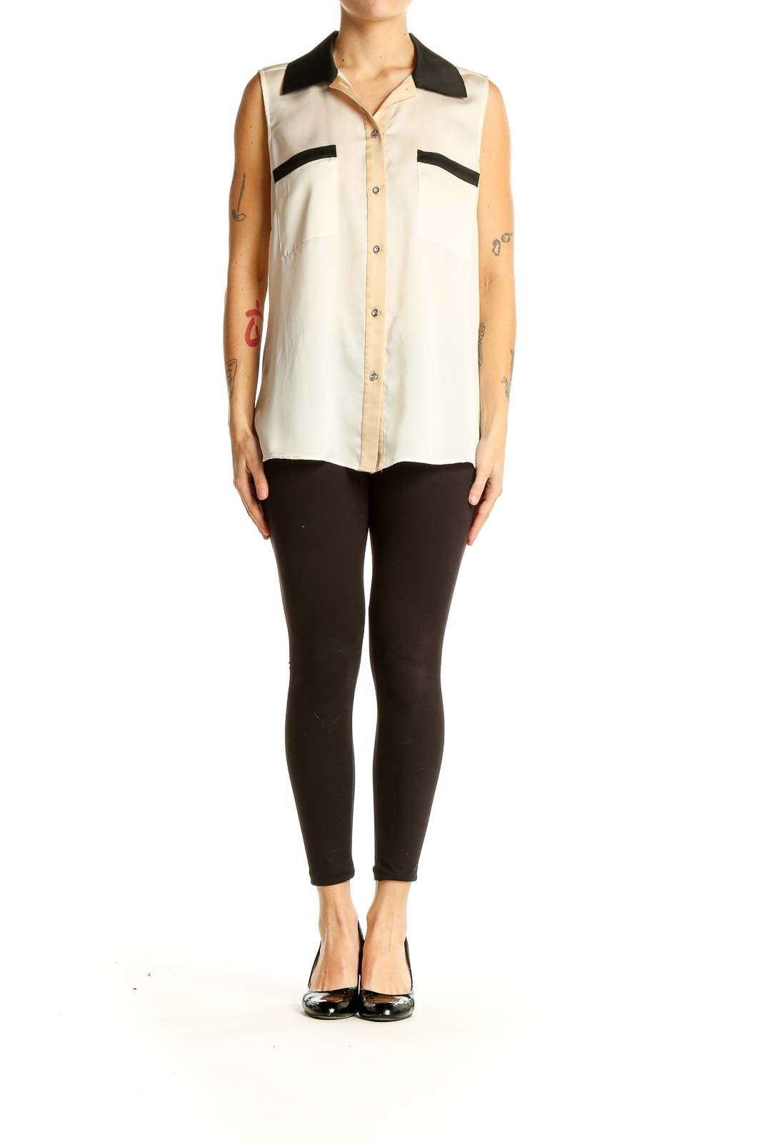 Front view of cream sleeveless blouse with black collar and pocket details