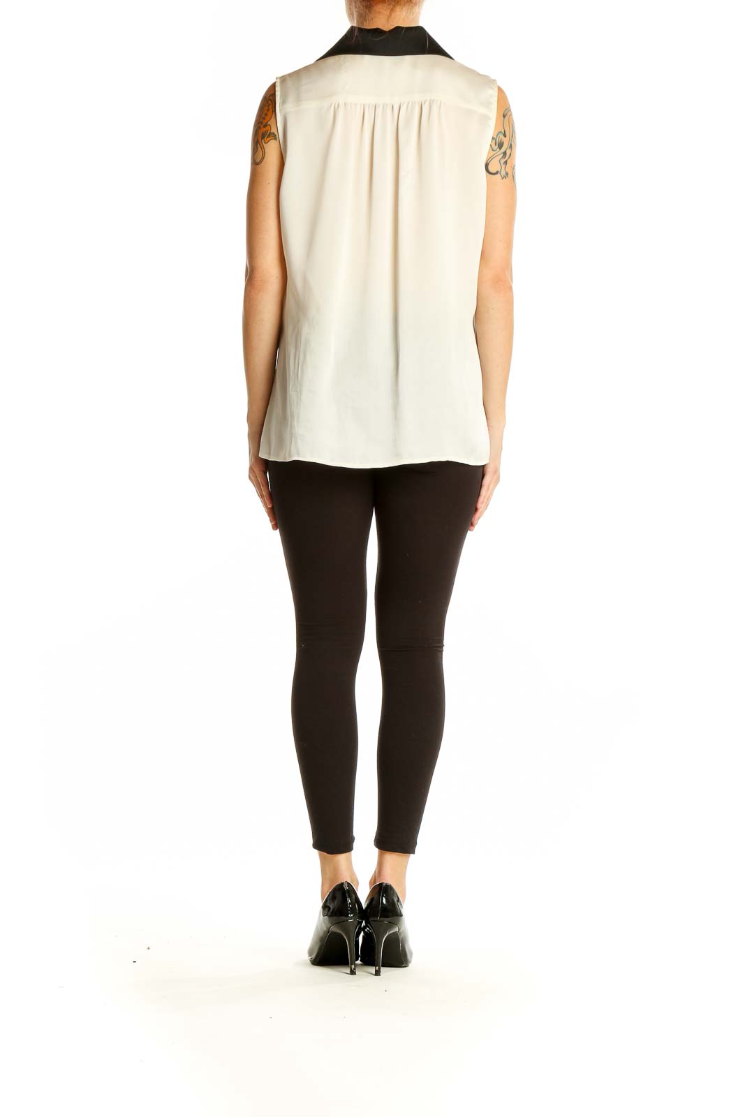 Side view of cream sleeveless blouse showing relaxed fit and length