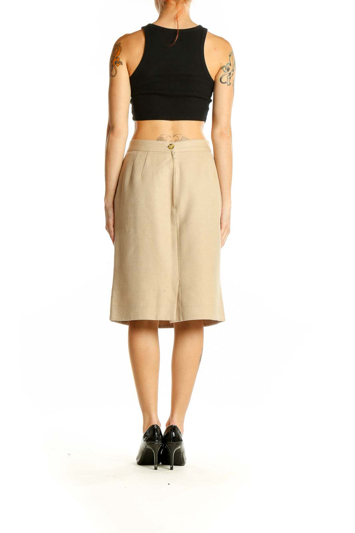 Side view of model wearing Valentino beige cashmere blend pencil skirt with black top