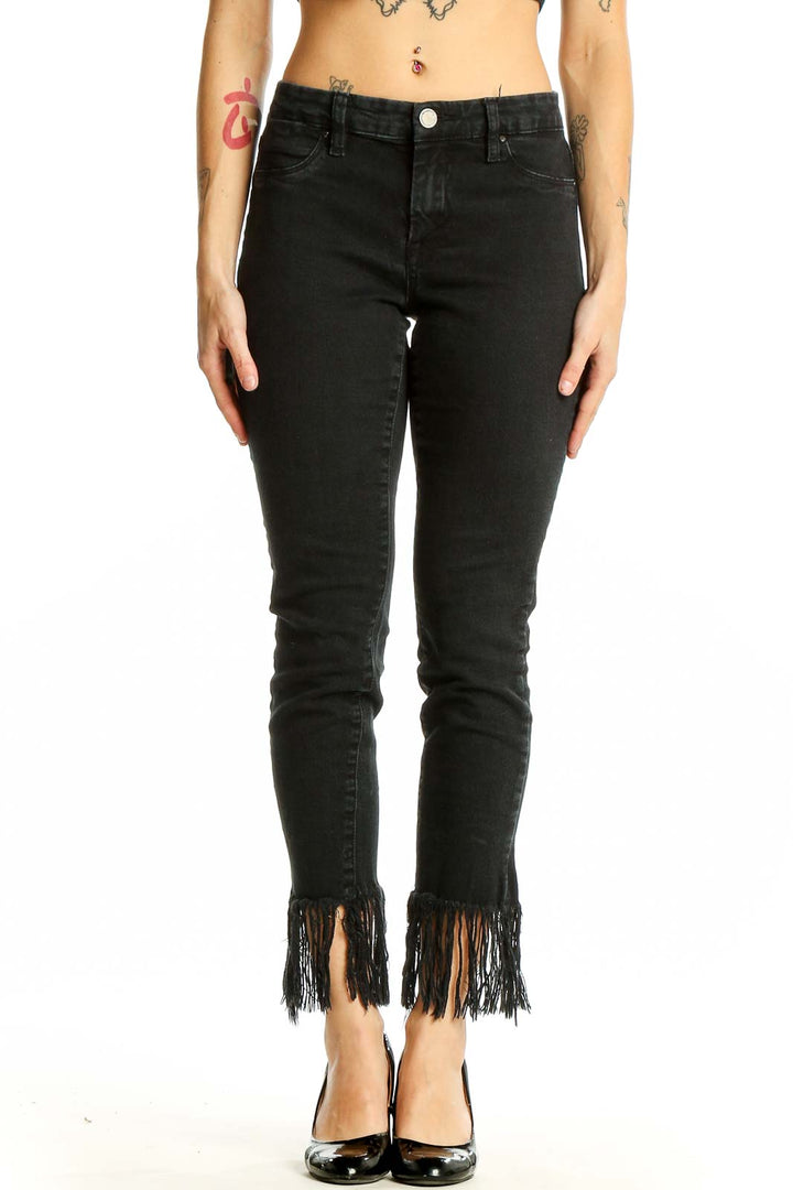 Front view of BLANKNYC black skinny jeans with fringe hem