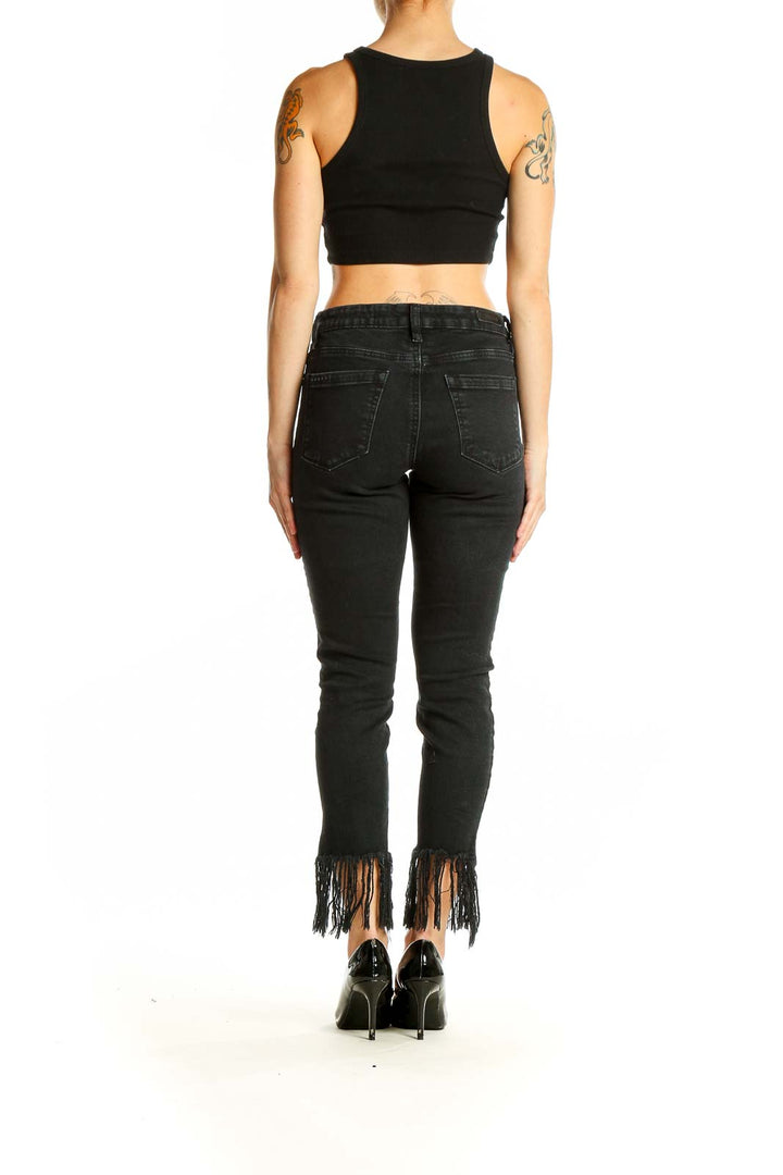 Back view of BLANKNYC black skinny jeans with fringe hem