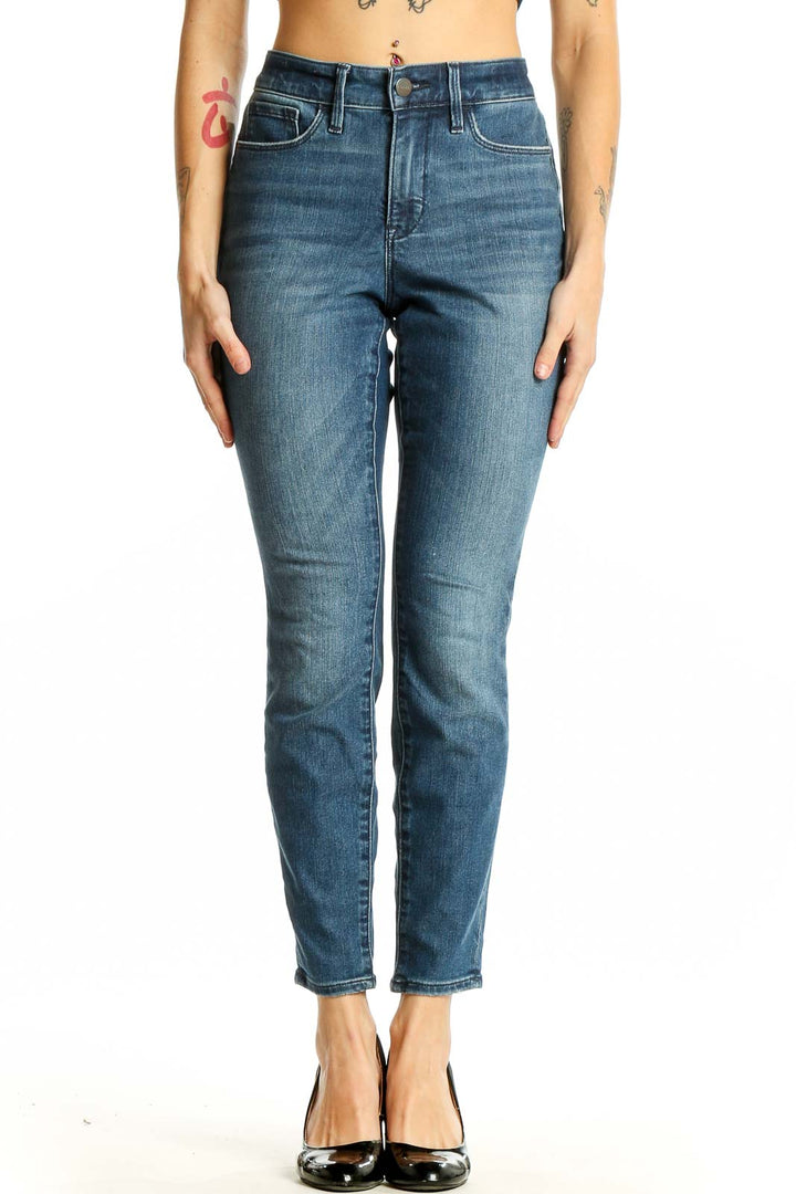 Front view of Athleta blue slim fit ankle-length jeans on model