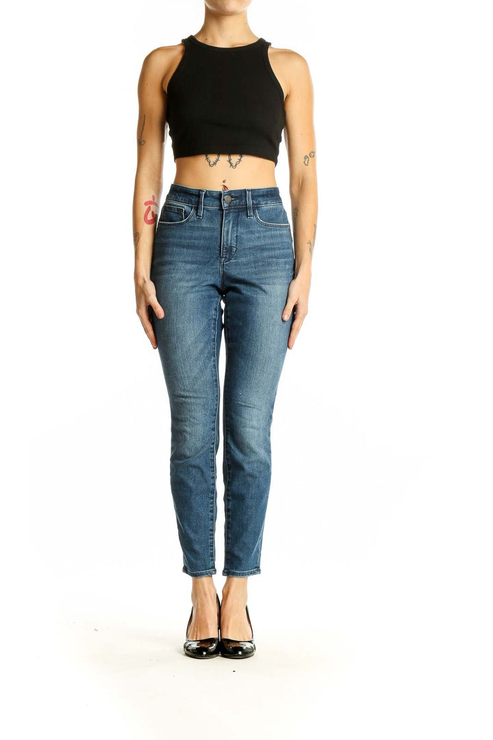 Front view of Athleta blue slim fit ankle-length jeans on model