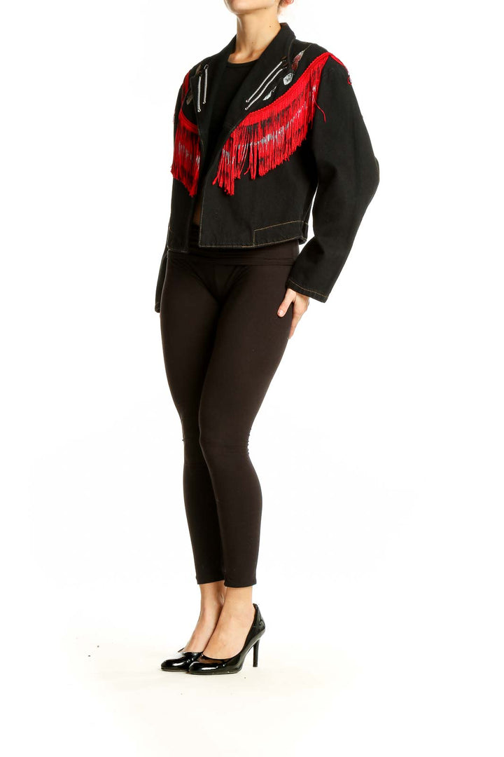 Front view of Wanted black denim jacket with red fringe and silver zipper accents