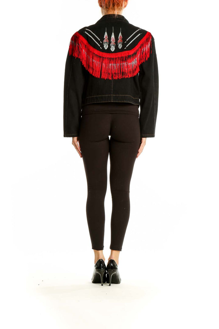 Back view of Wanted black denim jacket showcasing red fringe detail across shoulders