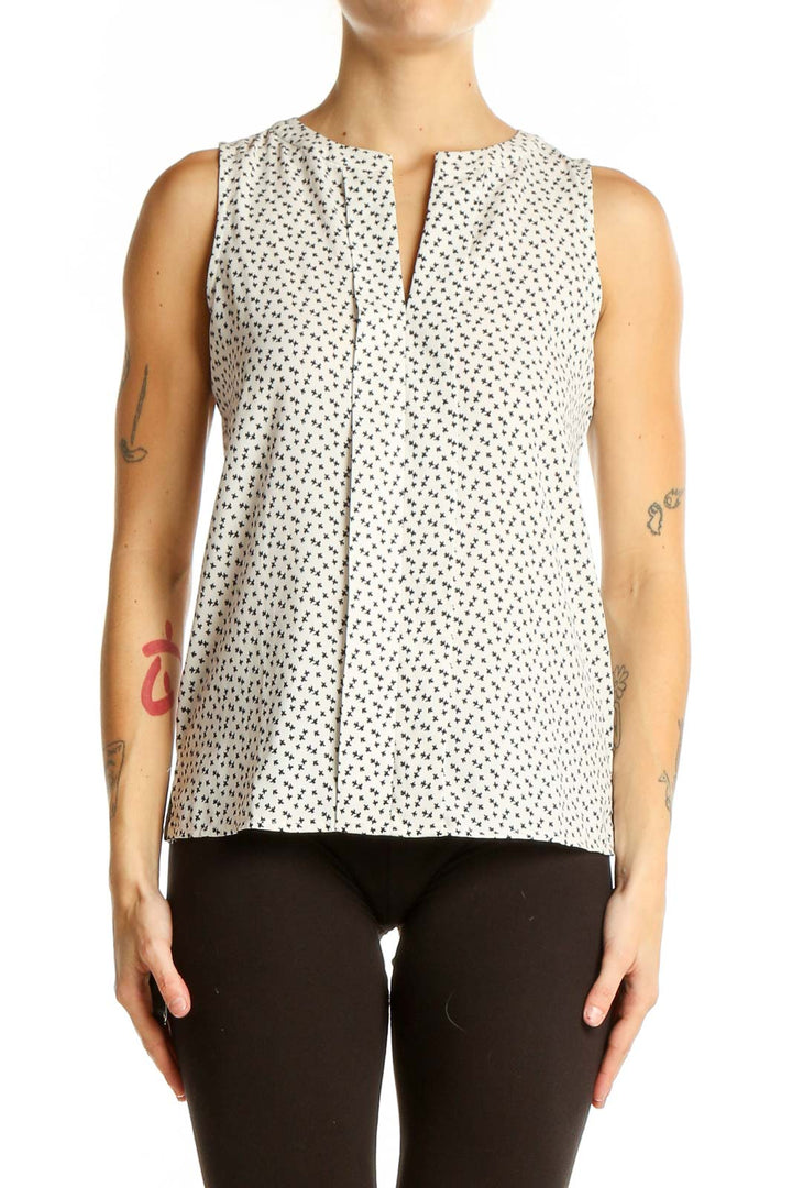 Front view of Ann Taylor white sleeveless blouse with black polka dots