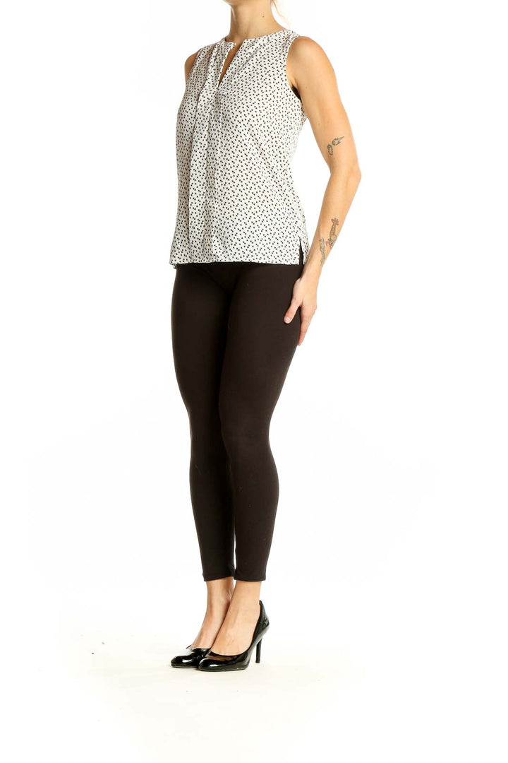 Front view of Ann Taylor white sleeveless blouse with black polka dots