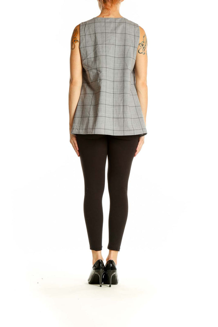 Side view of Banana Republic gray plaid sleeveless top showing ruffle and fit