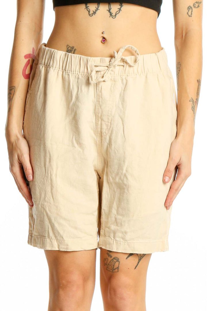 Front view of beige linen-blend drawstring shorts from onia