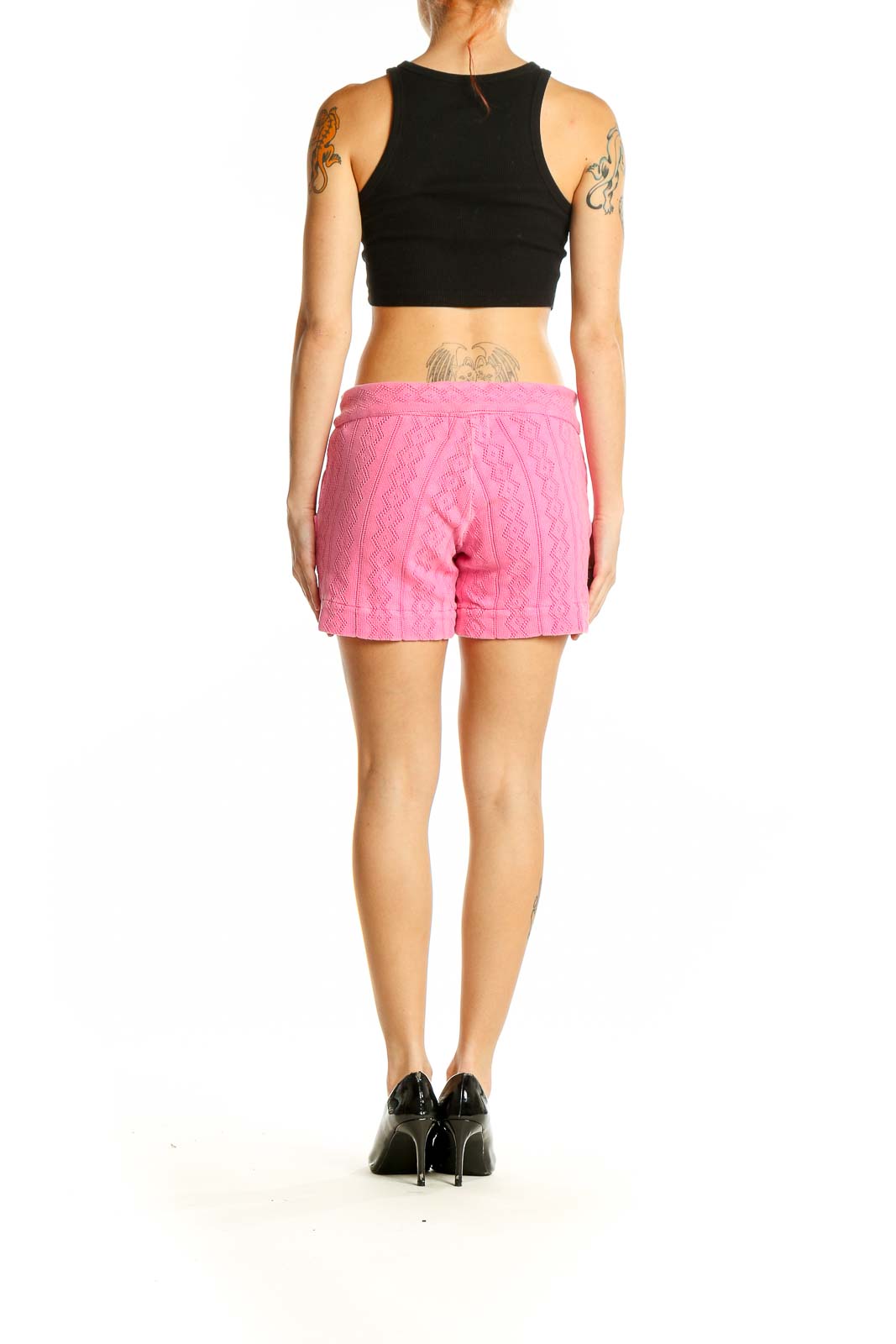 Side view of woman wearing pink MONROW shorts with black top