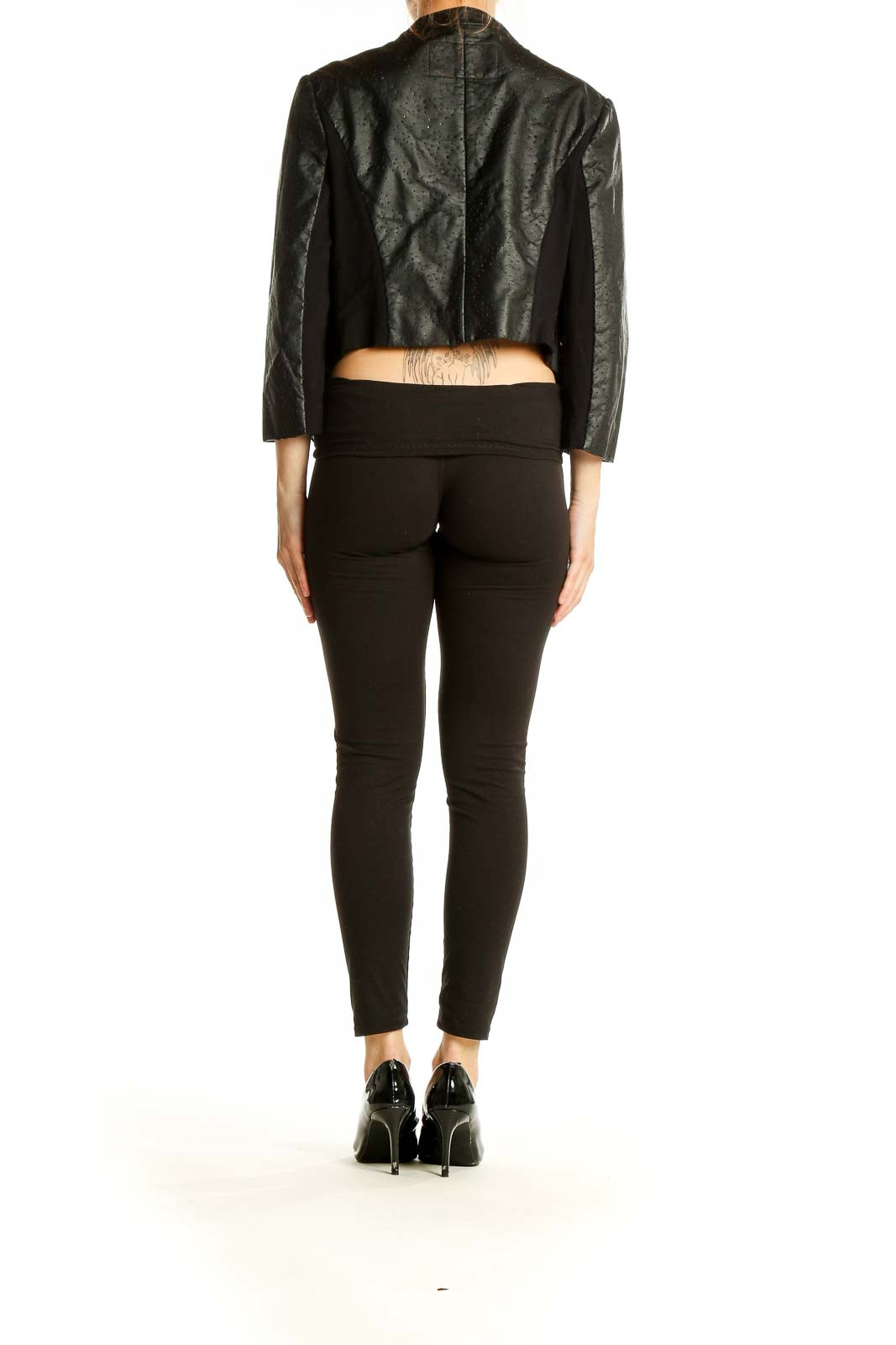 Back view of BCBG MaxAzria black perforated jacket showing cropped length